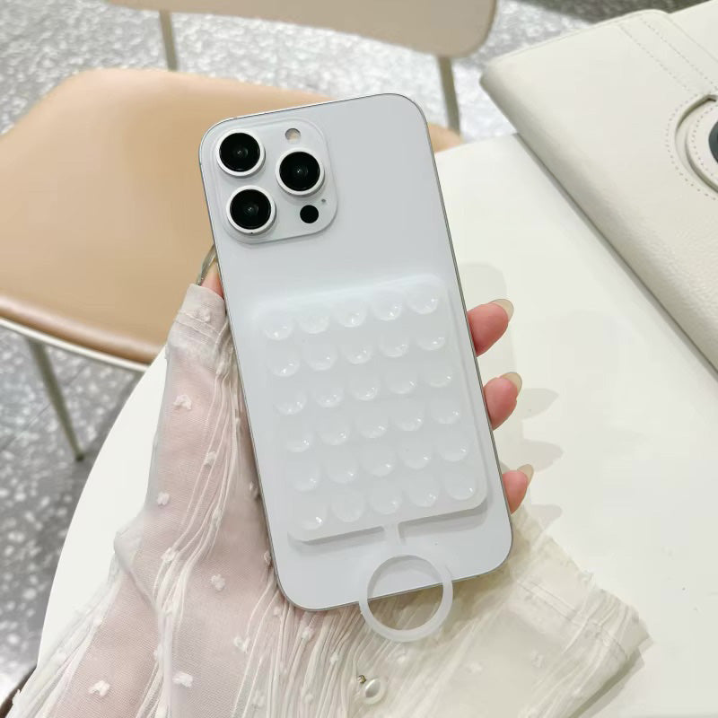 Silicone TecHub suction phone holder with sticky grip showing secure attachment to a smooth surface and phone placement.