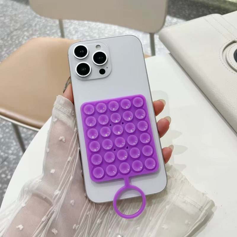 Silicone suction phone holder with sticky grip by TecHub, securely attaching to surfaces for hands-free phone use.
