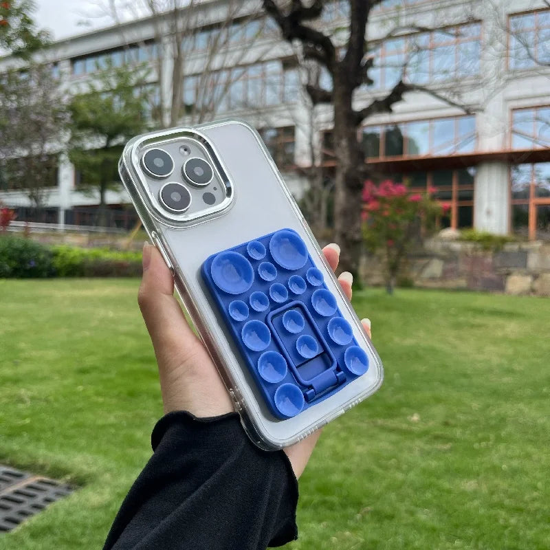 Silicone TecHub suction mobile phone folding stand holder showing a flexible, foldable phone stand with suction base on smooth surface.