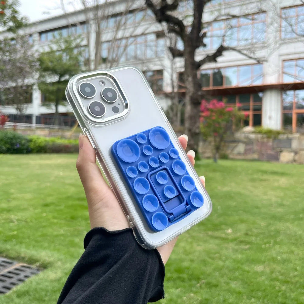 Silicone suction mobile phone folding stand holder by TecHub, showing the black flexible stand attached to a phone for hands-free use.
