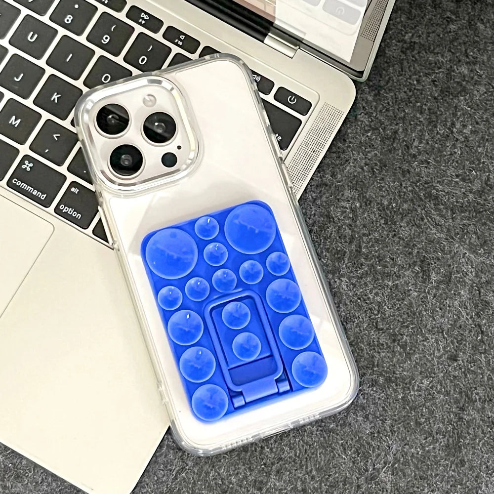 Silicone TecHub folding mobile phone stand holder with suction base, lightweight and adjustable for hands-free viewing.