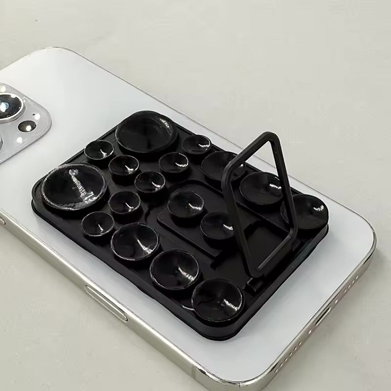 TecHub silicone suction mobile phone folding stand holder showing a compact, black adjustable holder with suction cup for stability.